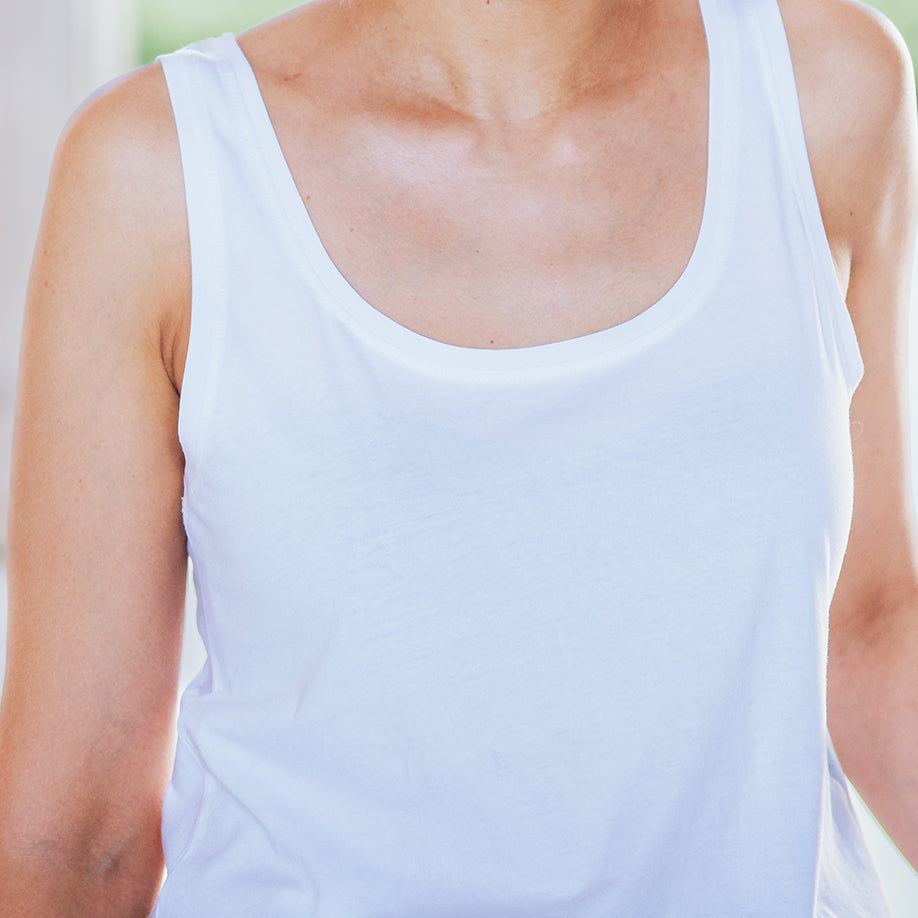 Sleeveless white top with black ink print on the back