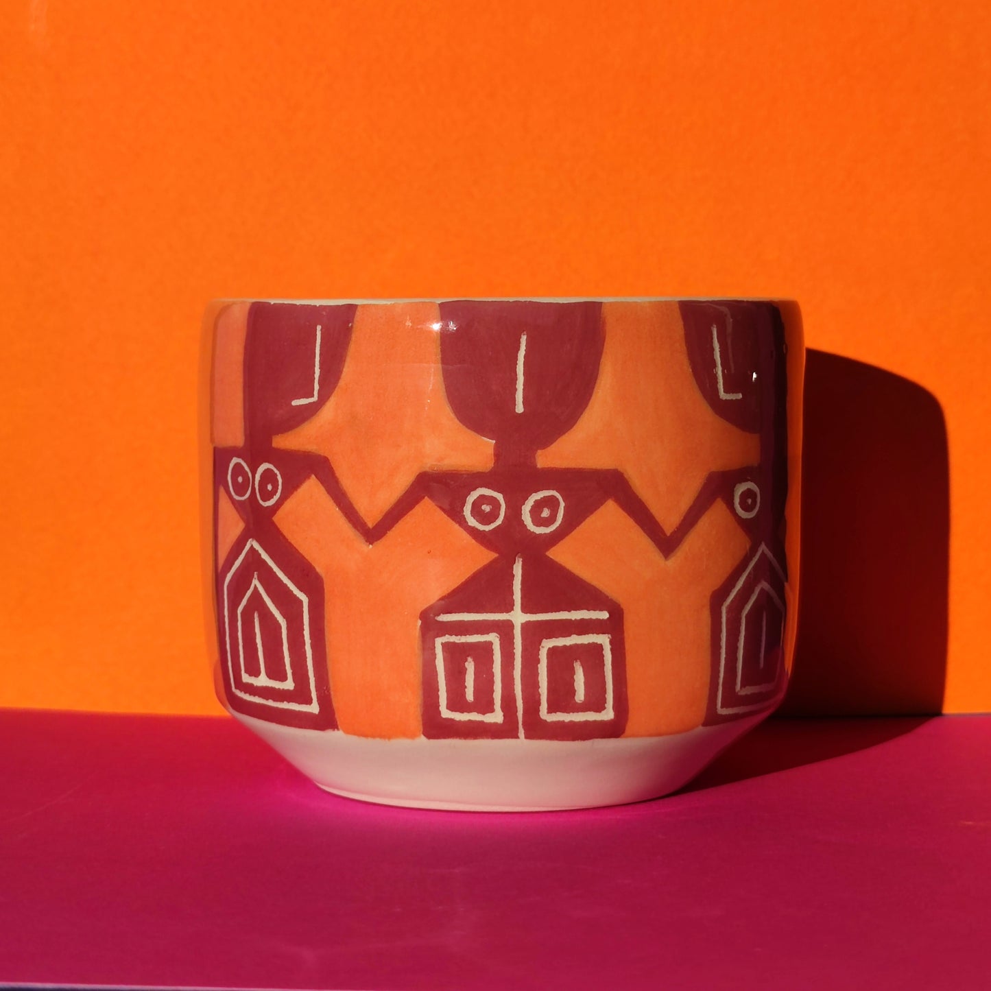 Colorful cappuccino cup in burgundy-orange