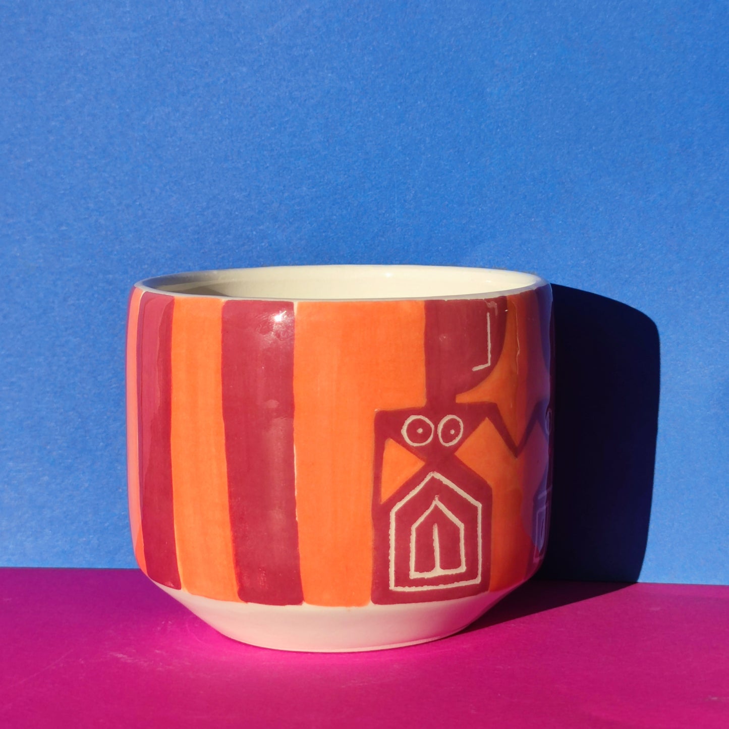 Colorful cappuccino cup in burgundy-orange