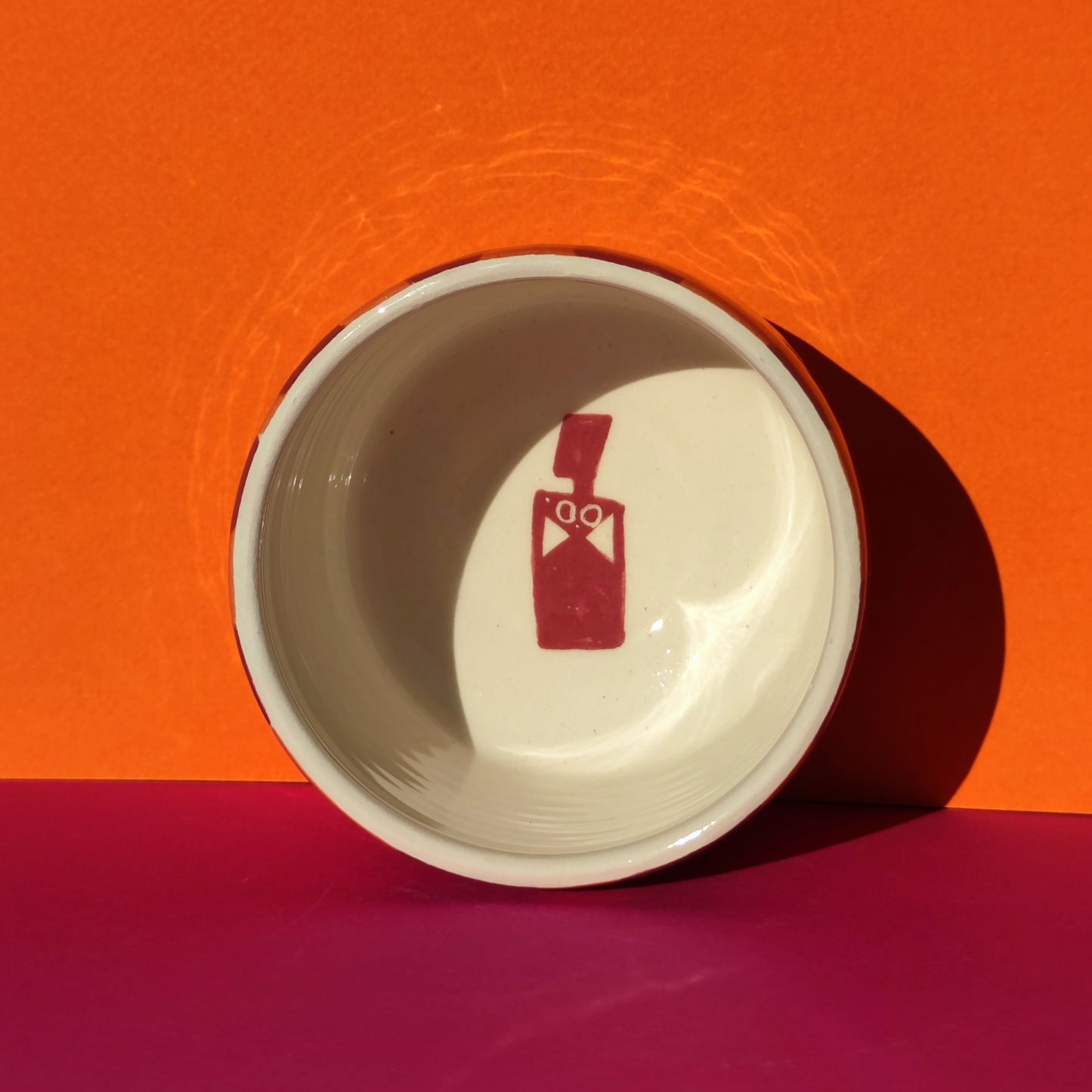 Colorful cappuccino cup in burgundy-orange