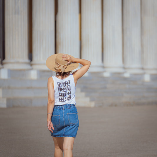 Sleeveless white top with black ink print on the back